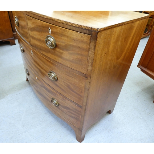 354 - An early 19thC mahogany bow front dressing chest with two short/two long drawers, raised on bracket ... 