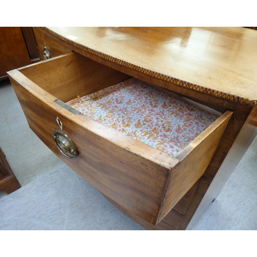 354 - An early 19thC mahogany bow front dressing chest with two short/two long drawers, raised on bracket ... 