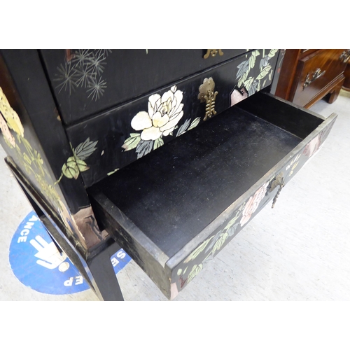 357 - A modern Chinese inspired black lacquered and overpainted, three drawer bedside chest, raised on blo... 