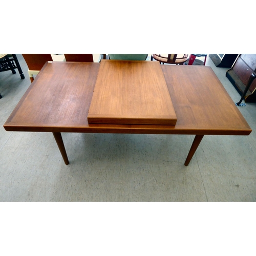 359 - A 1960/70s teak dining table, raised on turned, tapered legs  30