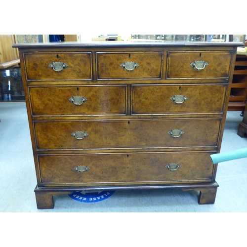 362 - A modern walnut dressing chest with five short/two long drawers, raised on bracket feet  35