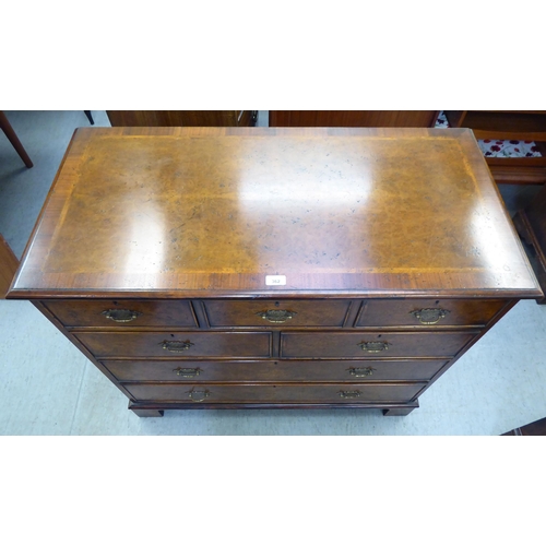 362 - A modern walnut dressing chest with five short/two long drawers, raised on bracket feet  35