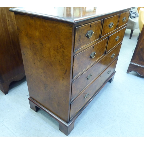 362 - A modern walnut dressing chest with five short/two long drawers, raised on bracket feet  35