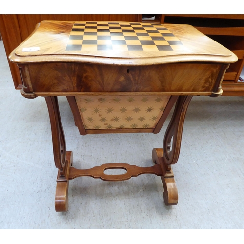 363 - A late Victorian mahogany work table with a hinged, chequerboard top, over a wool basket, raised on ... 