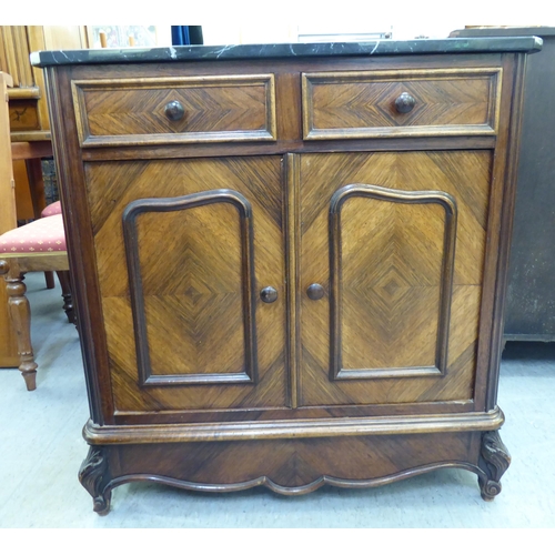 364 - A late 19thC kingswood side cabinet with a marble top, over two drawers and two doors, raised on cab... 