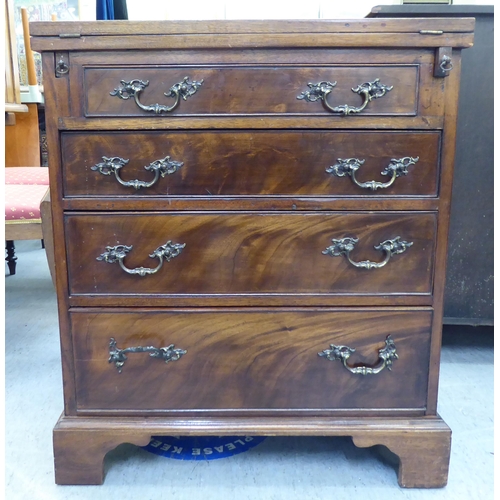 366 - An early 20thC mahogany bachelor chest with a foldover top and four long drawers, raised on bracket ... 