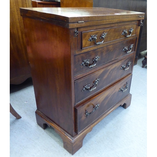 366 - An early 20thC mahogany bachelor chest with a foldover top and four long drawers, raised on bracket ... 