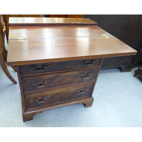 366 - An early 20thC mahogany bachelor chest with a foldover top and four long drawers, raised on bracket ... 