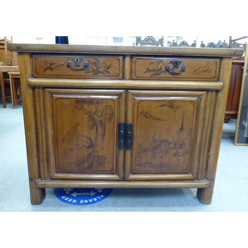 369 - A modern Chinese elm side cabinet with two drawers and two doors, raised on bracket feet  31