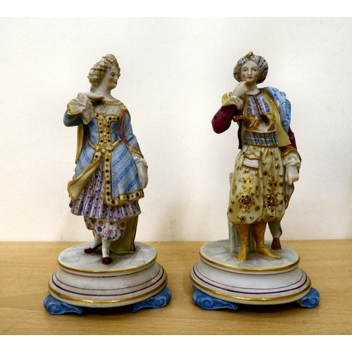 48 - Four painted bisque figures: to include one featuring a man in a frockcoat, on an oval pedestal ... 