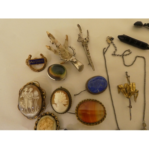 54 - Costume jewellery: to include a silver mounted bird's claw brooch; and a filigree worked, white meta... 