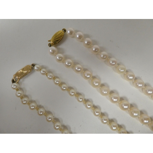 6 - Two cultured pearl necklaces, each on a 9ct gold clasp