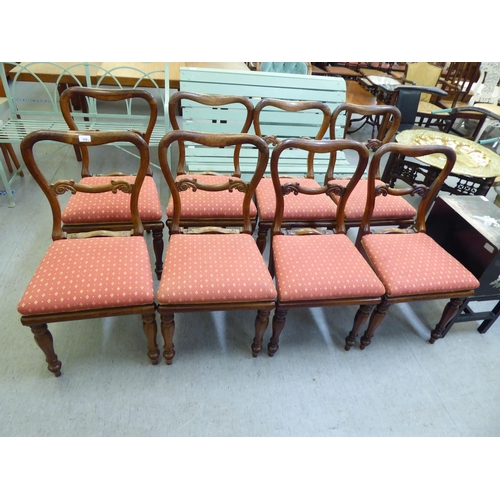 358 - A set of eight William IV rosewood framed balloon back dining chairs, raised on octagonal tapered le... 