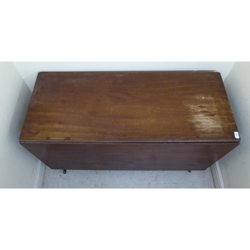 119 - A George III mahogany drop-leaf table, raised on turned legs and casters  29