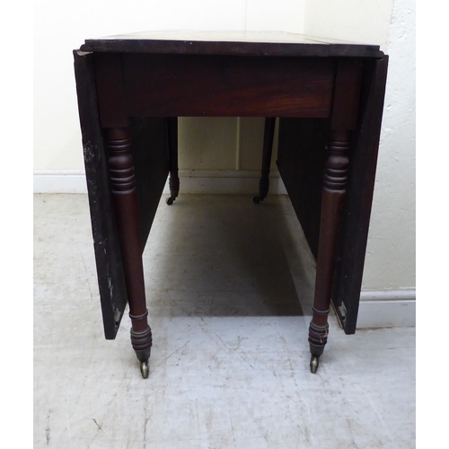 119 - A George III mahogany drop-leaf table, raised on turned legs and casters  29