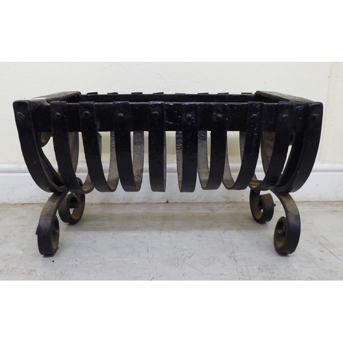 122 - Early 20thC hearth related items, viz. a black painted wrought iron fire basket  12