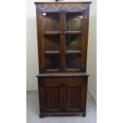 128 - A mid 20thC Old English style oak one-piece corner cabinet  70