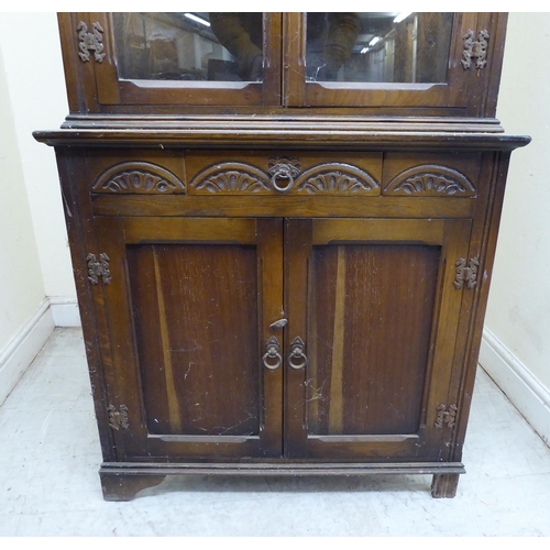 128 - A mid 20thC Old English style oak one-piece corner cabinet  70