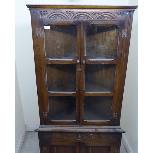 128 - A mid 20thC Old English style oak one-piece corner cabinet  70