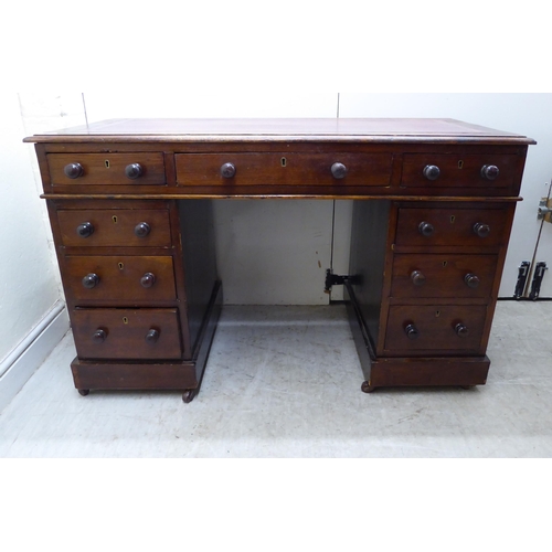 132 - A late Victorian/Edwardian mahogany nine drawer, twin pedestal desk, on a plinth and casters  2... 