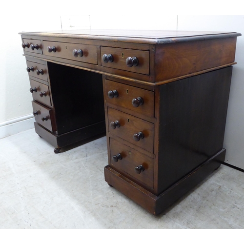 132 - A late Victorian/Edwardian mahogany nine drawer, twin pedestal desk, on a plinth and casters  2... 