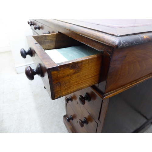 132 - A late Victorian/Edwardian mahogany nine drawer, twin pedestal desk, on a plinth and casters  2... 