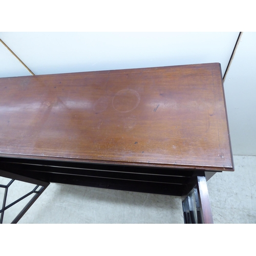 133 - An Edwardian string inlaid and marquetry mahogany, two door glazed bookcase, raised on tapered legs ... 