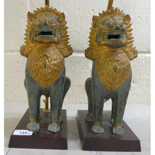 149 - A pair of modern cast metal table lamps, fashioned as Dogs of Fo, on plinths  16