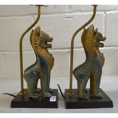 149 - A pair of modern cast metal table lamps, fashioned as Dogs of Fo, on plinths  16