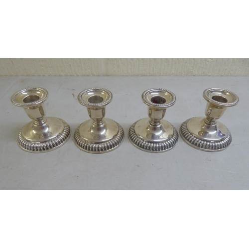 16 - A set of four loaded Sterling silver dwarf candlesticks  3.5