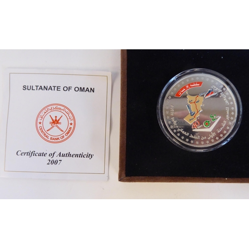 201 - A mixed lot: to include a silver proof Sultanate of Oman commemorative coin  boxed