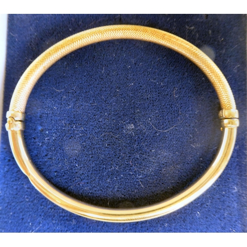 221 - A 9ct gold hollow bangle