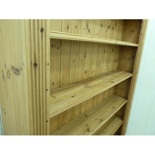 232 - A modern pine open breakfront bookcase with four height adjustable shelves, on a plinth  76