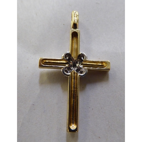 372 - A 9ct gold and diamond set crucifix pendant