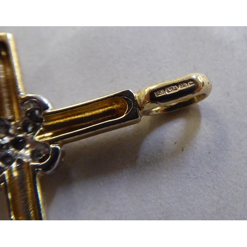 372 - A 9ct gold and diamond set crucifix pendant