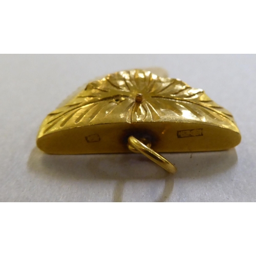 373 - A yellow metal pendant, on a ring, set with a shark tooth