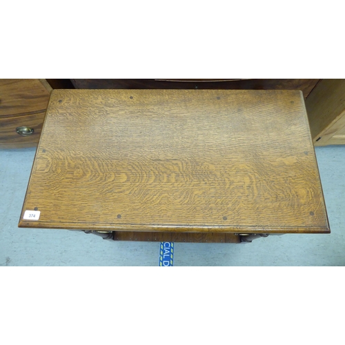 374 - A modern oak side table with a frieze drawer, raised on turned legs, united by an undershelf and blo... 