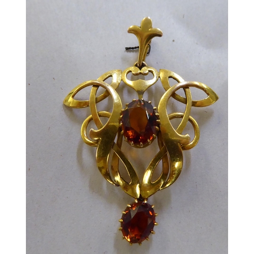 376 - A 9ct gold Art Nouveau design pendant, claw set with two citrine coloured stones