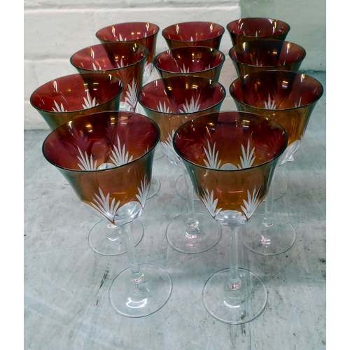 59 - A set of eleven clear and cranberry coloured, thumb moulded and foliage design pedestal wines