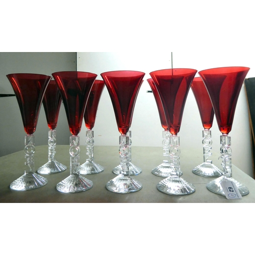 62 - A set of ten clear and cranberry coloured pedestal wines, the stems moulded to read 'Noel'