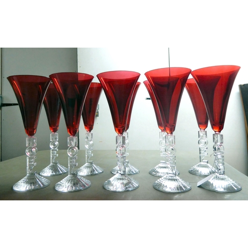 63 - A set of ten clear and cranberry coloured pedestal wines, the stems moulded to read 'Noel'