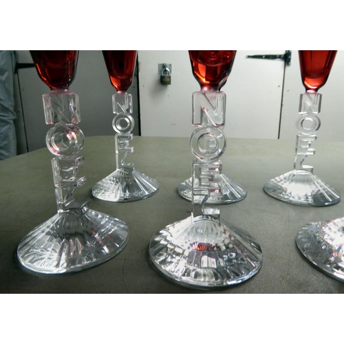 63 - A set of ten clear and cranberry coloured pedestal wines, the stems moulded to read 'Noel'