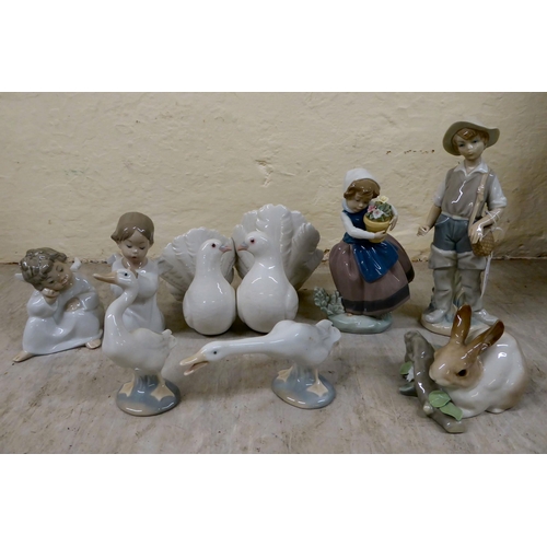 69 - Eight Lladro porcelain figures and animals: to include a group of two doves  4.5