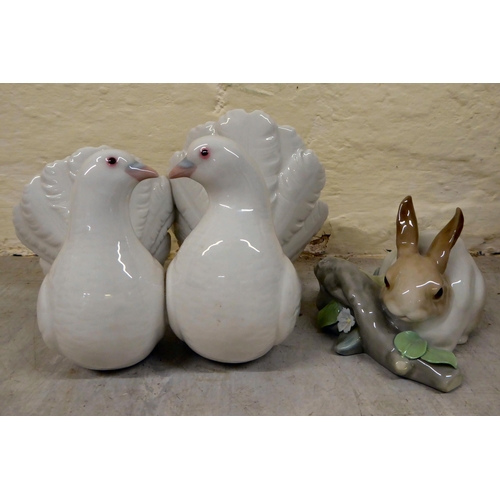 69 - Eight Lladro porcelain figures and animals: to include a group of two doves  4.5