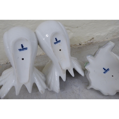 69 - Eight Lladro porcelain figures and animals: to include a group of two doves  4.5