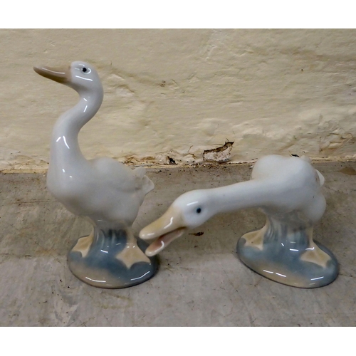 69 - Eight Lladro porcelain figures and animals: to include a group of two doves  4.5