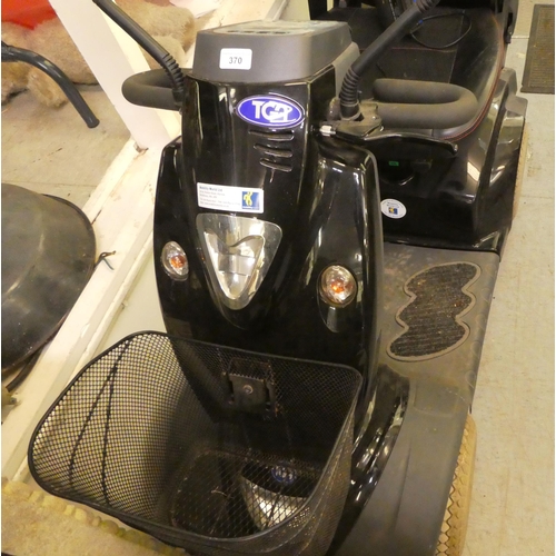 370 - A TGA Mobility World battery powered, four wheeled scooter with power leads (to be sold as seen, nei... 