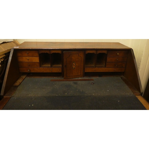 98 - A George III oak bureau, the fall flap over two short/three long drawers, raised on bracket feet&nbs... 