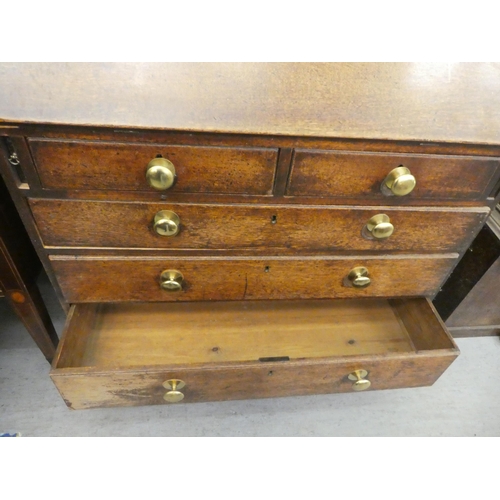 98 - A George III oak bureau, the fall flap over two short/three long drawers, raised on bracket feet&nbs... 