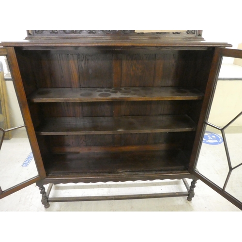 97 - A 1920s oak two door, glazed bookcase on stand  54